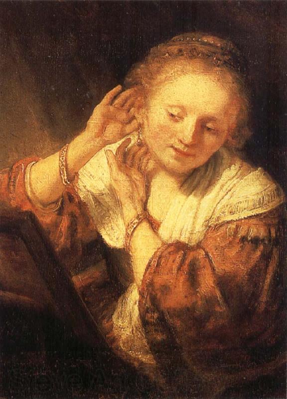 REMBRANDT Harmenszoon van Rijn Young Woman Trying on Earrings